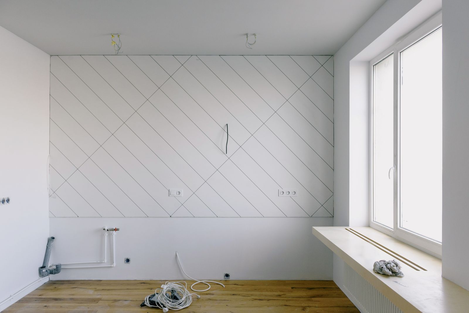 Room in renovation with tile layout lines and plumbing rough-in (stock image)